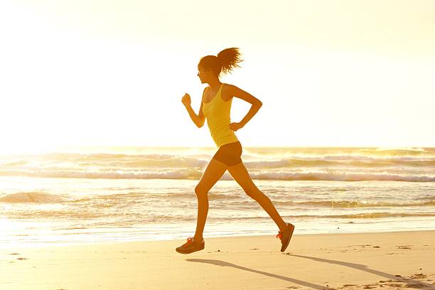 istock Woman running at the beach 530502624