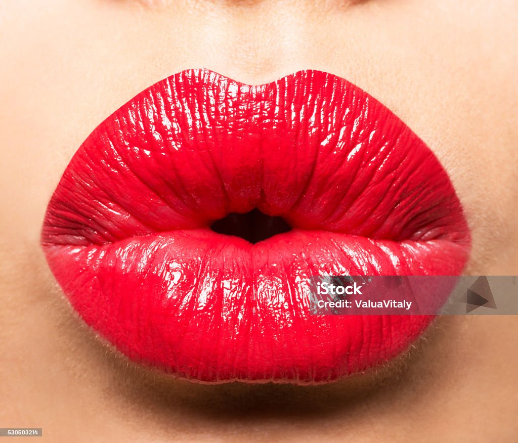 Woman's lips with red lipstick and  kiss gesture Human Lips Stock Photo
