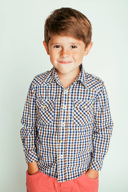 istock little cute boy on white background gesture smiling close up 530503432
