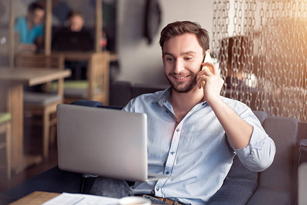 istock Delighted smiling guy talking on cell phone 530503690