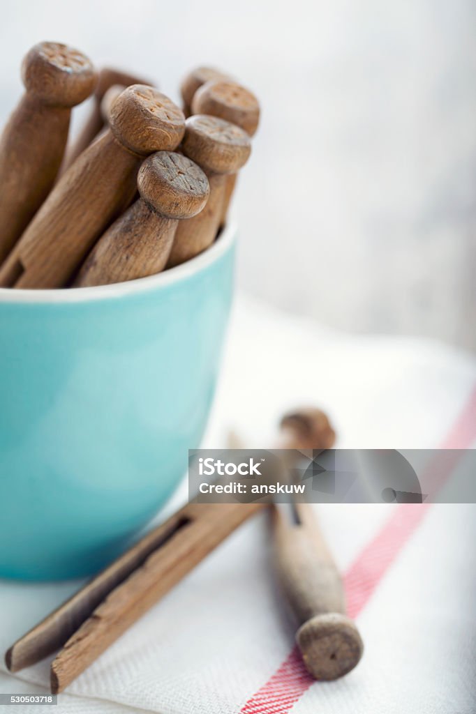 Wooden vintage clothespins4 Wooden clothespins in a blue cup and white clean towel with vintage editing - housework concept Blue Stock Photo