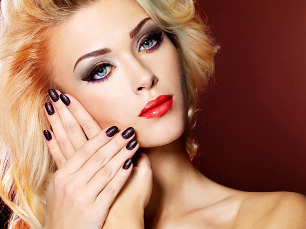 istock Beautiful  woman with black nails and red lips 530504040