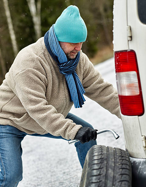 istock Male and tire exchange 530504515