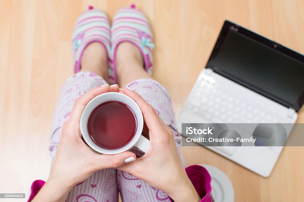 Woman having a cup of tea Woman having a cup of tea first person Pajamas Stock Photo