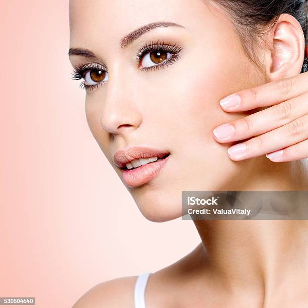 Beautiful Woman Touching Skin Of Face Stock Photo - Download Image Now - Adult, Adults Only, Beautiful People