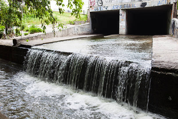 istock Water stream flowing out the underground tunnel 530505441