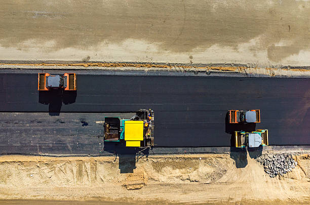 Road rollers working on the construction site aerial view stock photo