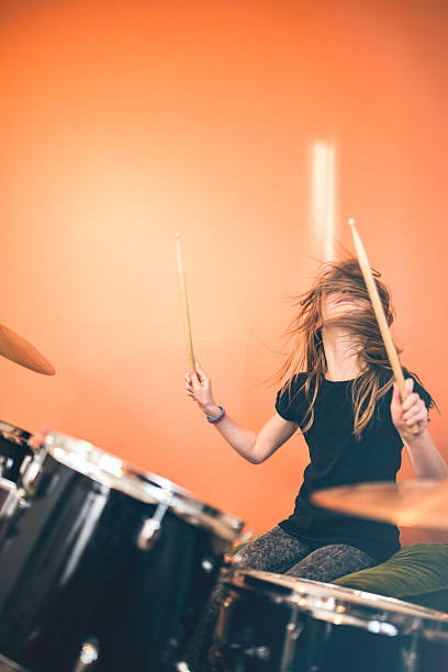 istock Girl Playing Rock and Roll Drums 530507502