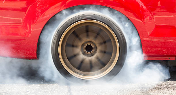Drag racing car burn tire for the race Drag racing car burns rubber off its tires in preparation for the race drag racing stock pictures, royalty-free photos & images