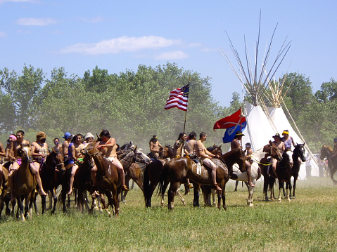 Crow Agency, Montana USA - June 27, 2009: Reenactment of the Battle of the Little Bighorn known as Custer's Last Stand. Smoke swirls among the teepees as guns are fired by U.S. 7th Cavalry soldiers at the Arapahoe, Cheyenne and Lakota Indians.