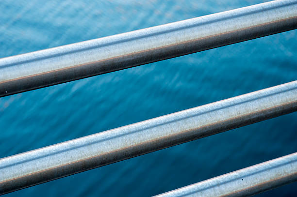 Railing by harbor Stainless steel railing showing effects of exposure to salt air harborwalk stock pictures, royalty-free photos & images