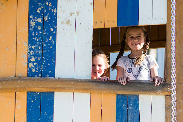 istock Two girls playing in a sandpit house. 530508918