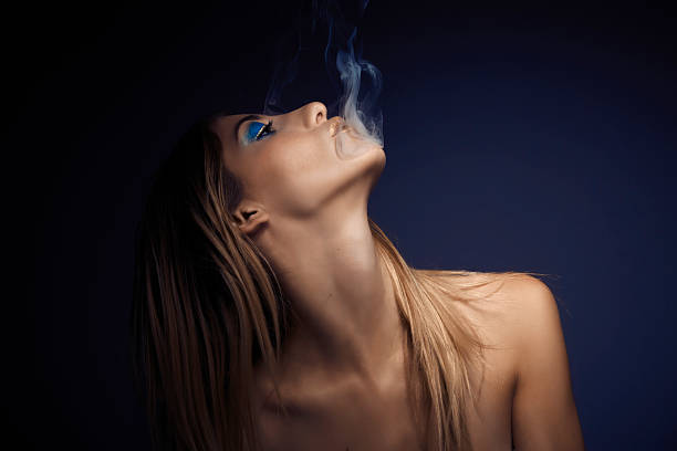 istock Young sexy woman smoking cigarette 530509441