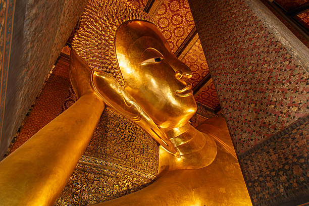 istock Reclining Buddha gold statue face. Wat Pho, Bangkok, Thailand 530509681