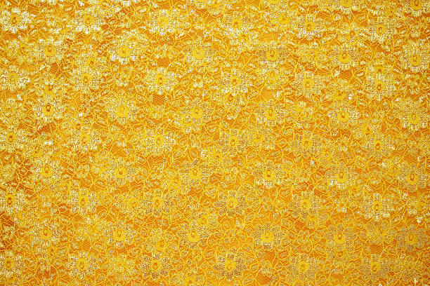 istock Gold lace sits on a gold silk background 530510660