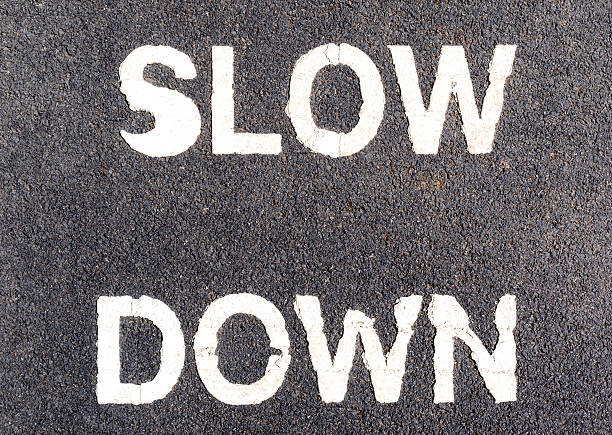 istock Close up slow down marking on street, for warning drivers. 530511824