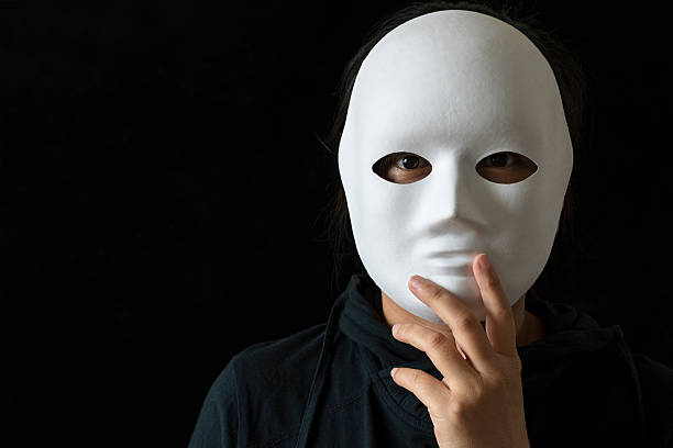 istock girl wearing mask in black backgrounds 530514278