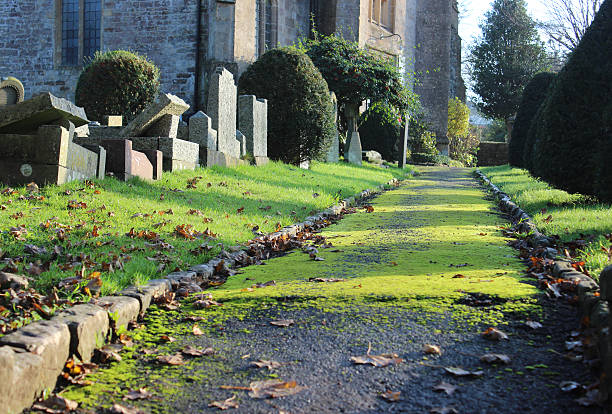 istock Neglected RIP gravestones / crosses, church graveyard cemetery image, leaning / falling-over 530516239