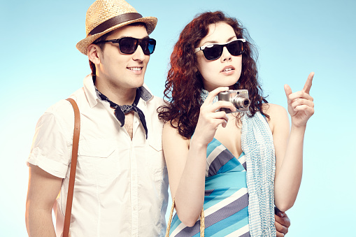 Young couple wearing sunglasses wearing the sights