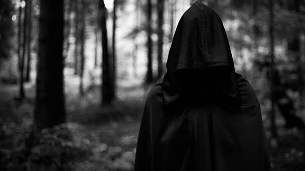 Dark demon in forest. Grim reaper in search of victim stock photo