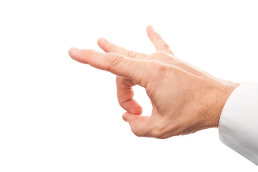 Close up photo of business man hand preparing flick with his index finger isolated on white background