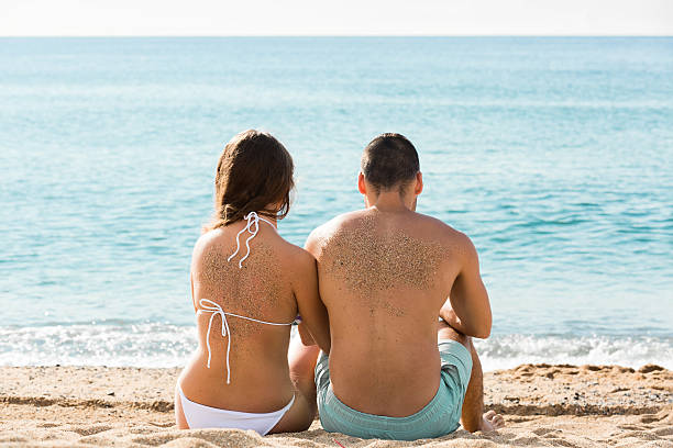 istock Happy pair relaxing on sand beach 530519719