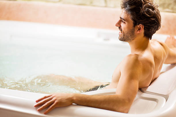 istock Man relaxing in hot tub. 530521133