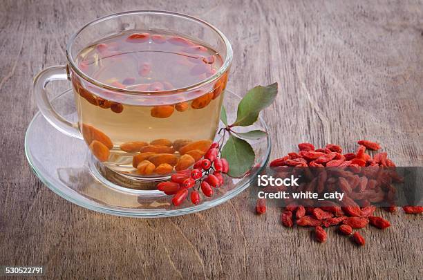 Goji Fresh Antioxidant Tea On Wooden Background Stock Photo - Download Image Now - Antioxidant, Barberry Family, Berry Fruit