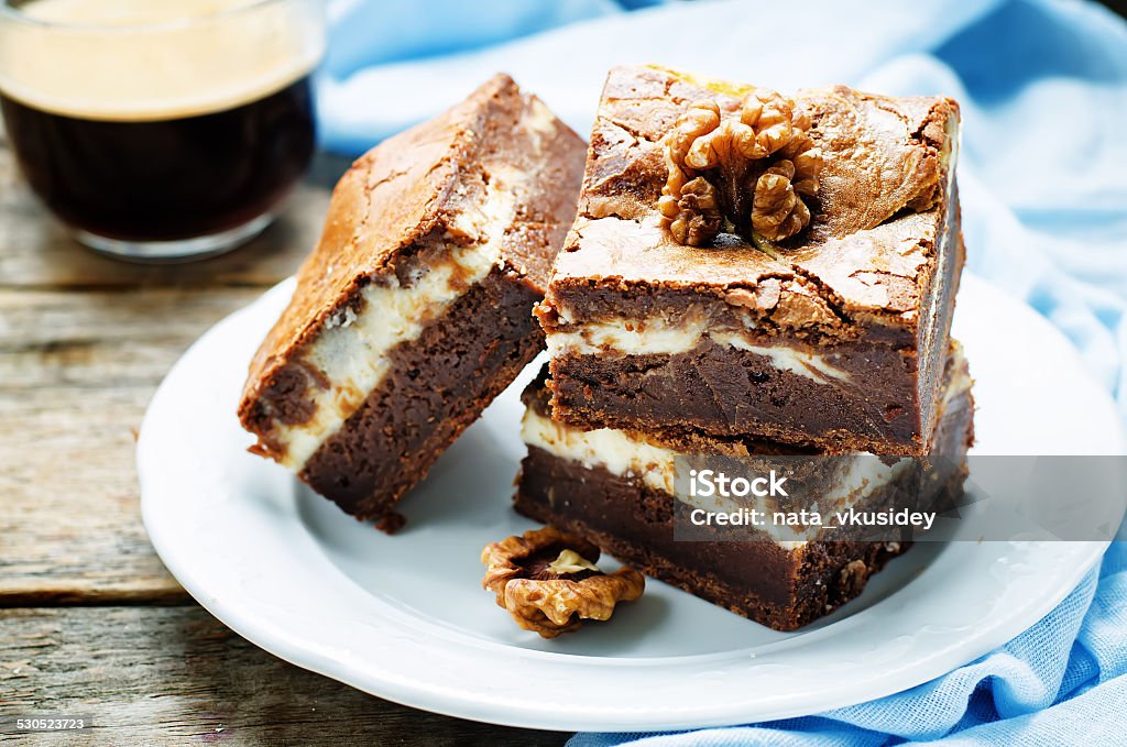 brownie with cream cheese brownie with cream cheese on a dark wood background. tinting. selective focus Autumn Stock Photo