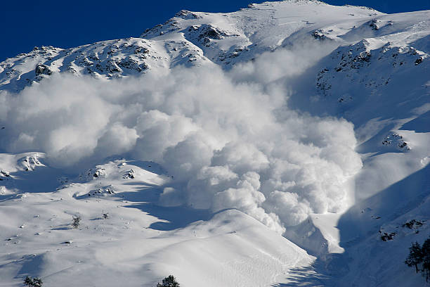 Dry snow avalanche with a powder cloud.Caucasus. Dry snow avalanche with a powder cloud close to the village Terskol, Elbrus region avalanche stock pictures, royalty-free photos & images