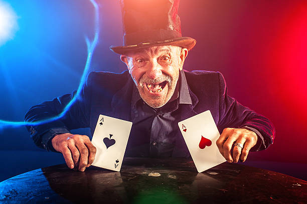 istock Senior man making trick with playing cards 530529103