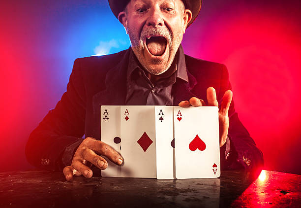 istock Senior man making trick with playing cards 530529107