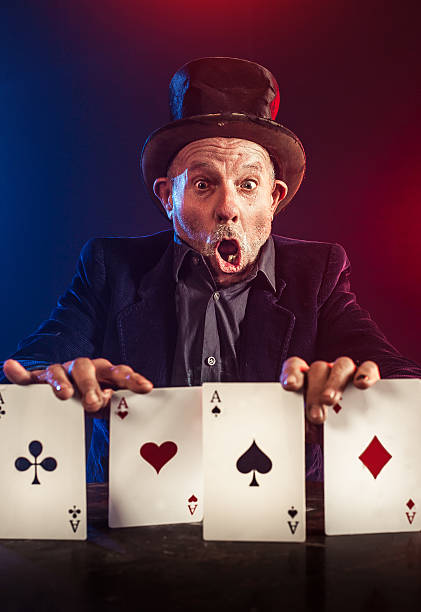 istock Senior man making trick with playing cards 530529109