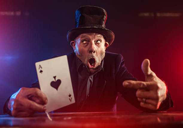 istock Senior man making trick with playing cards 530529123