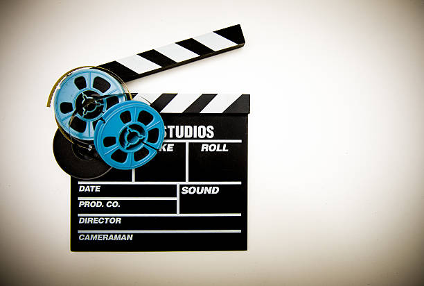 istock Clapper board and 8mm film reels color effect 530530057
