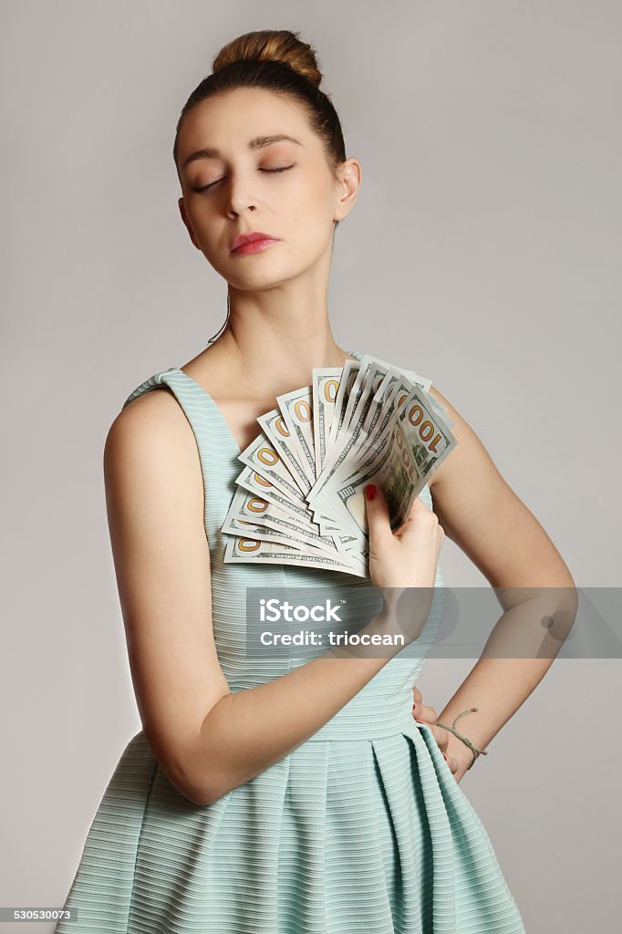 Woman with money Fashion portrait of young woman with bunch of dollar bills Currency Stock Photo