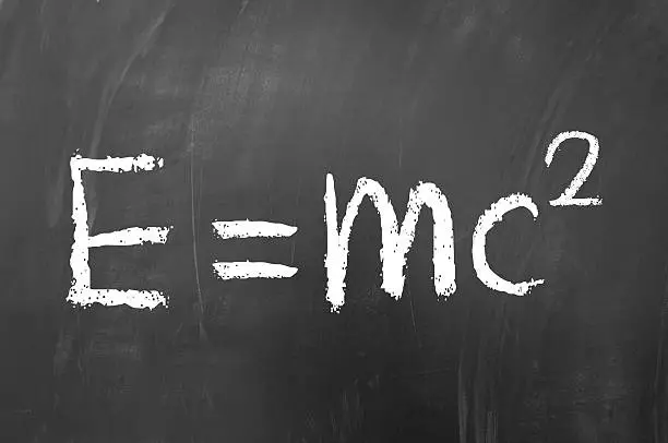 E equals mc squared drawn with white chalk on blackboard