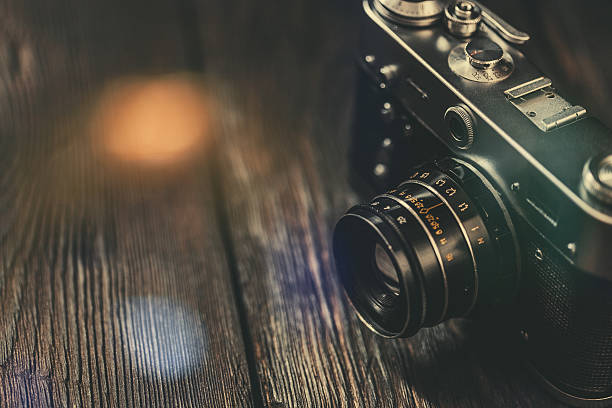 istock Vintage photo camera on old wooden table 530530631