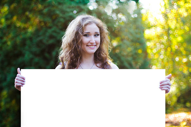 istock attractive young woman holding a billboard 530538661
