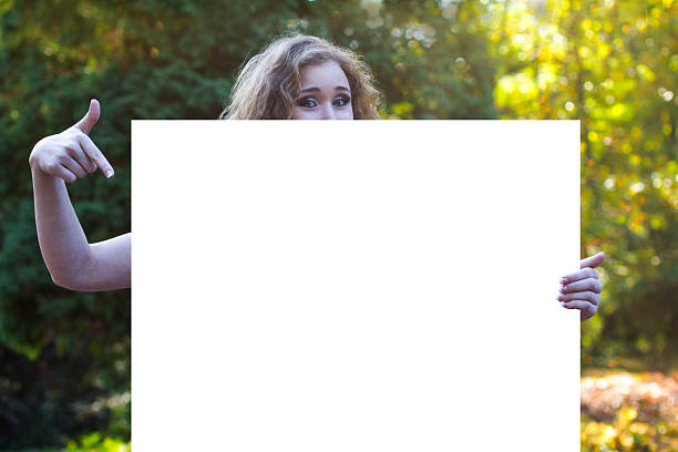 istock attractive young woman points to a billboard 530538677