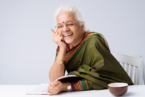 Laughing Indian woman with a book