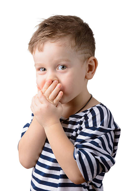istock little boy  closed mouth with hands 530541247