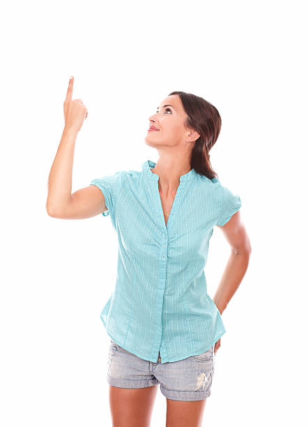 istock Attractive girl in short jeans pointing up 530544323