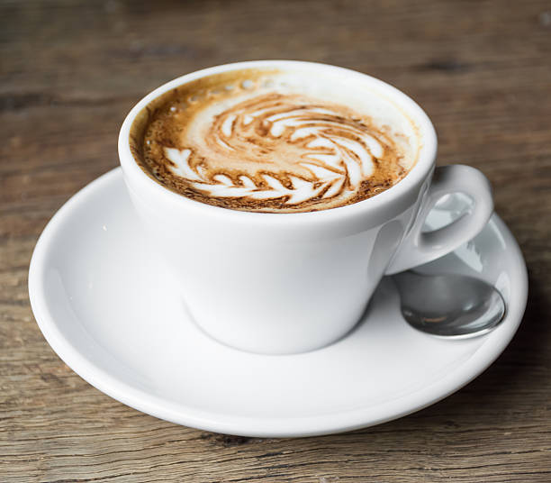 istock Cappuccino coffe cup on wooden table. 530544351