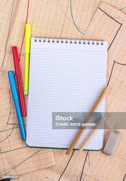 Open Notebook On The Background Of Graph Paper And Pencil Stock Photo - Download Image Now