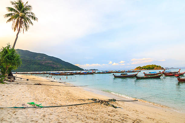 istock Long tailed boat on beach with white sand and sunset 530547205