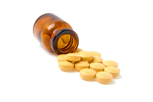 istock Pills and bottle on a white background 530549077