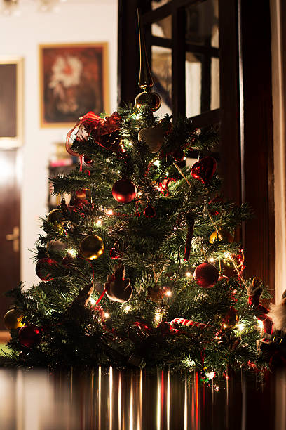 istock Christmas tree with lights on at home 530550683