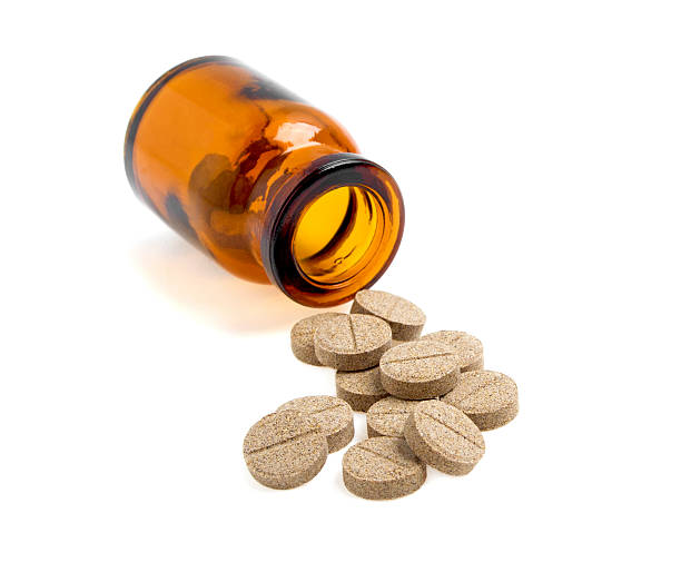 istock Herbal pills and bottle on a white background 530552383