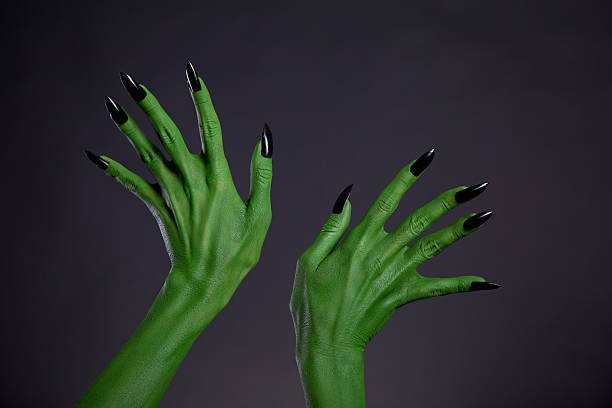 istock Green monster hands with black nails, real body-art 530553073